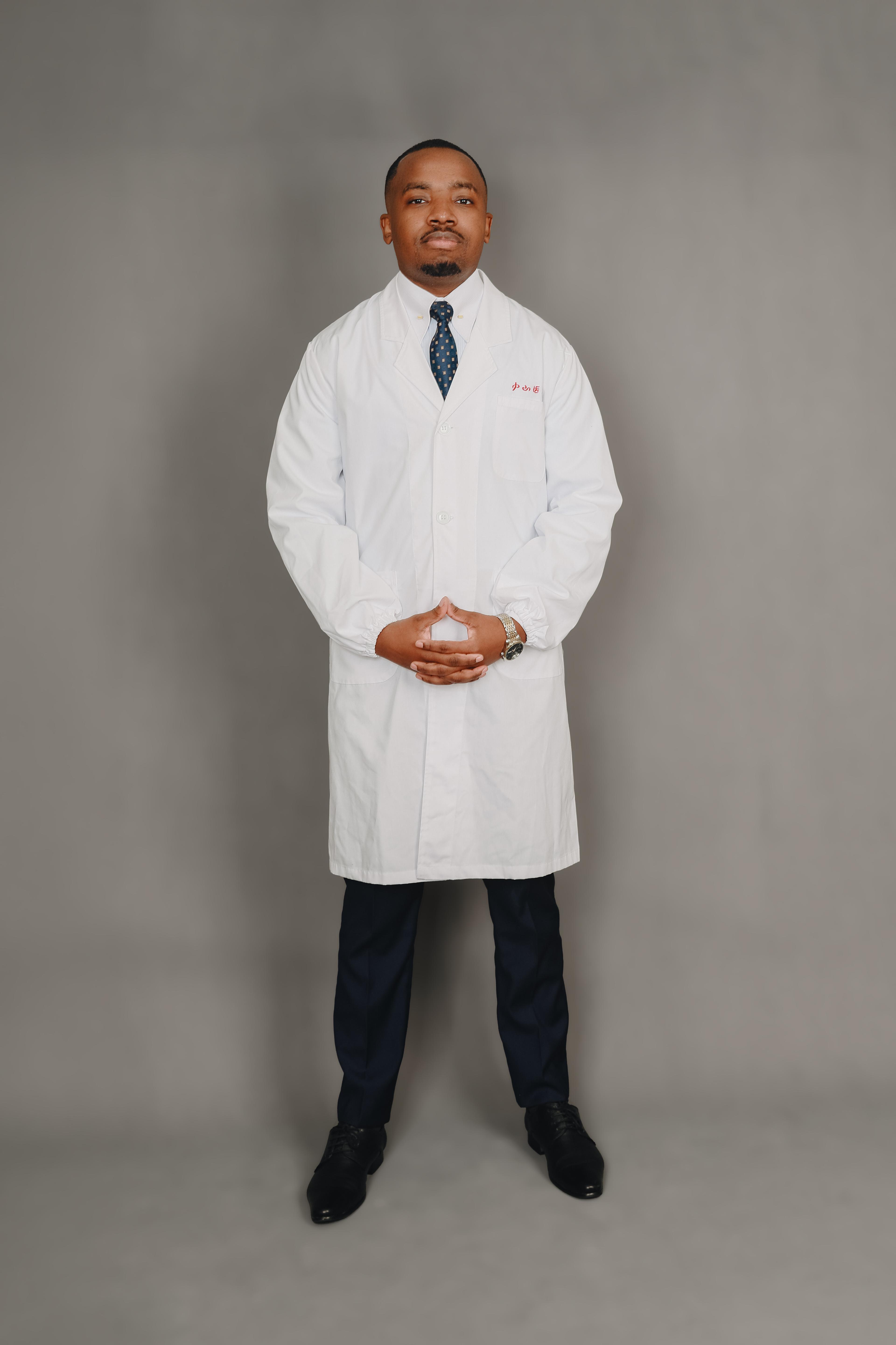 Dr. Pascal Kwangwari in a white coat