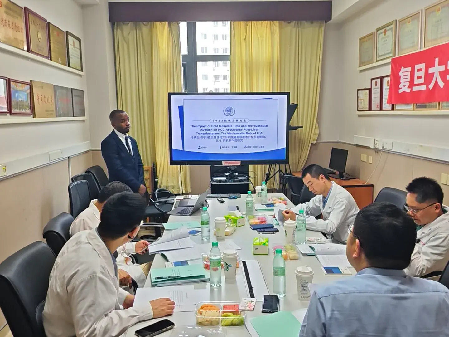 Dr. Pascal Kwangwari presenting research to a specialist team at Fudan Zhongshan Hospital