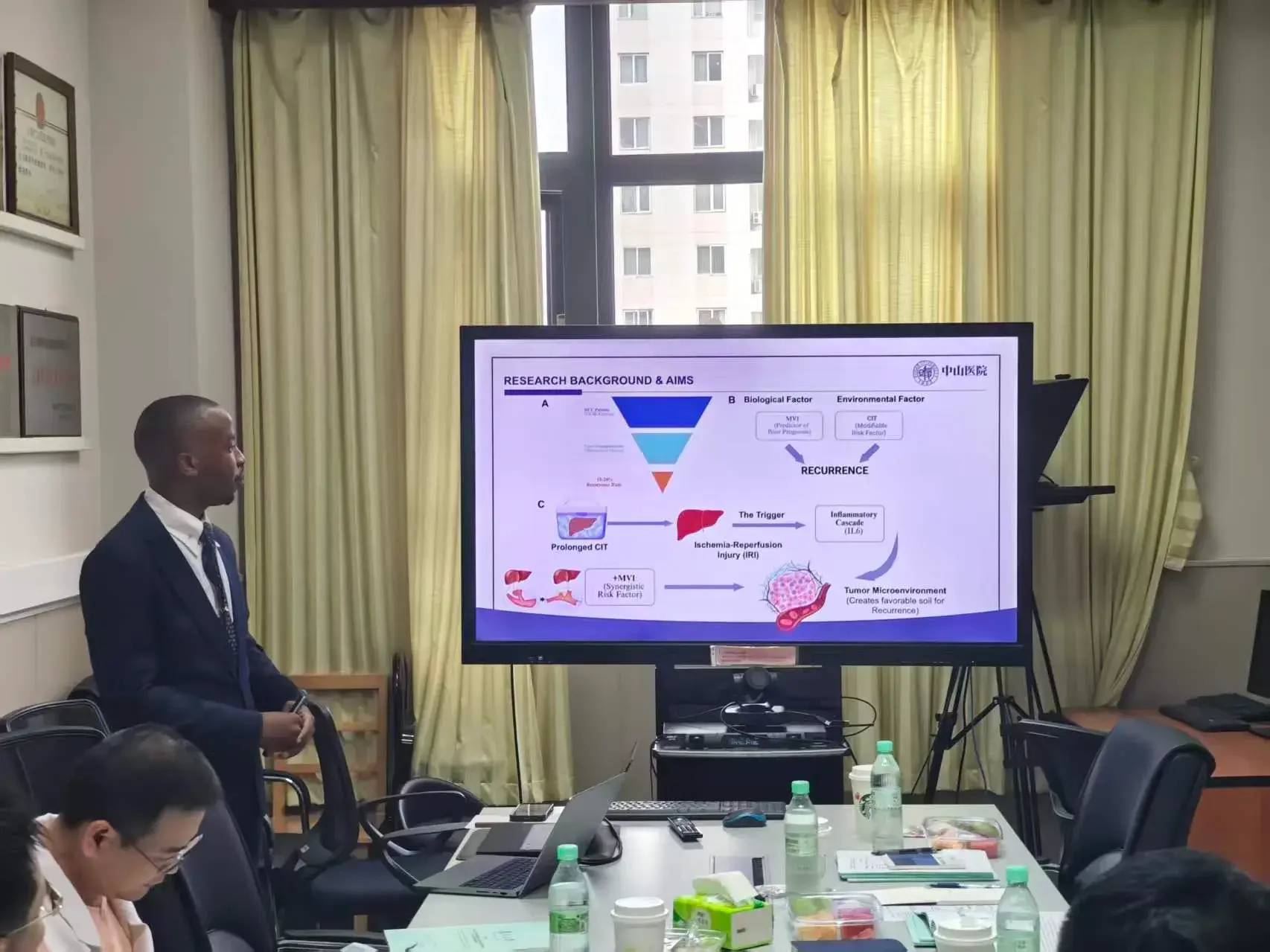Dr. Pascal Kwangwari presenting liver disease research inside a Chinese hospital
